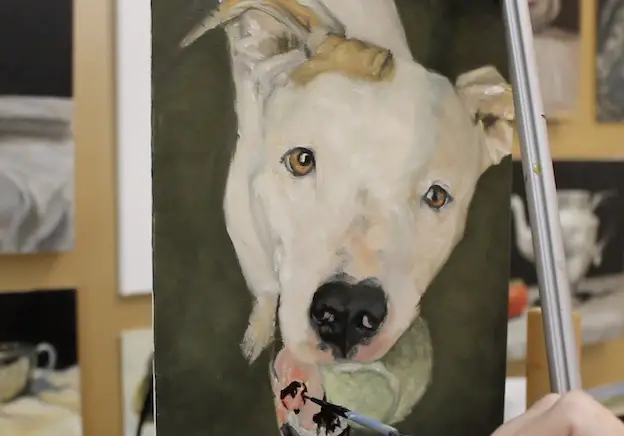 Painting the mouth on a pet portrait painting of a pit bull.